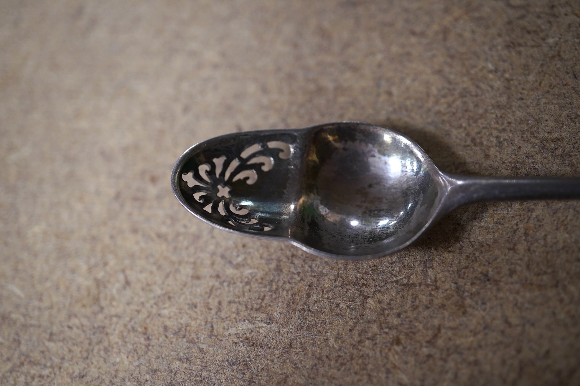 A George II silver mote spoon with acorn shaped picture back bowl, maker's mark for Elizabeth Oliver, circa 1755, 13.6cm. Condition - fair